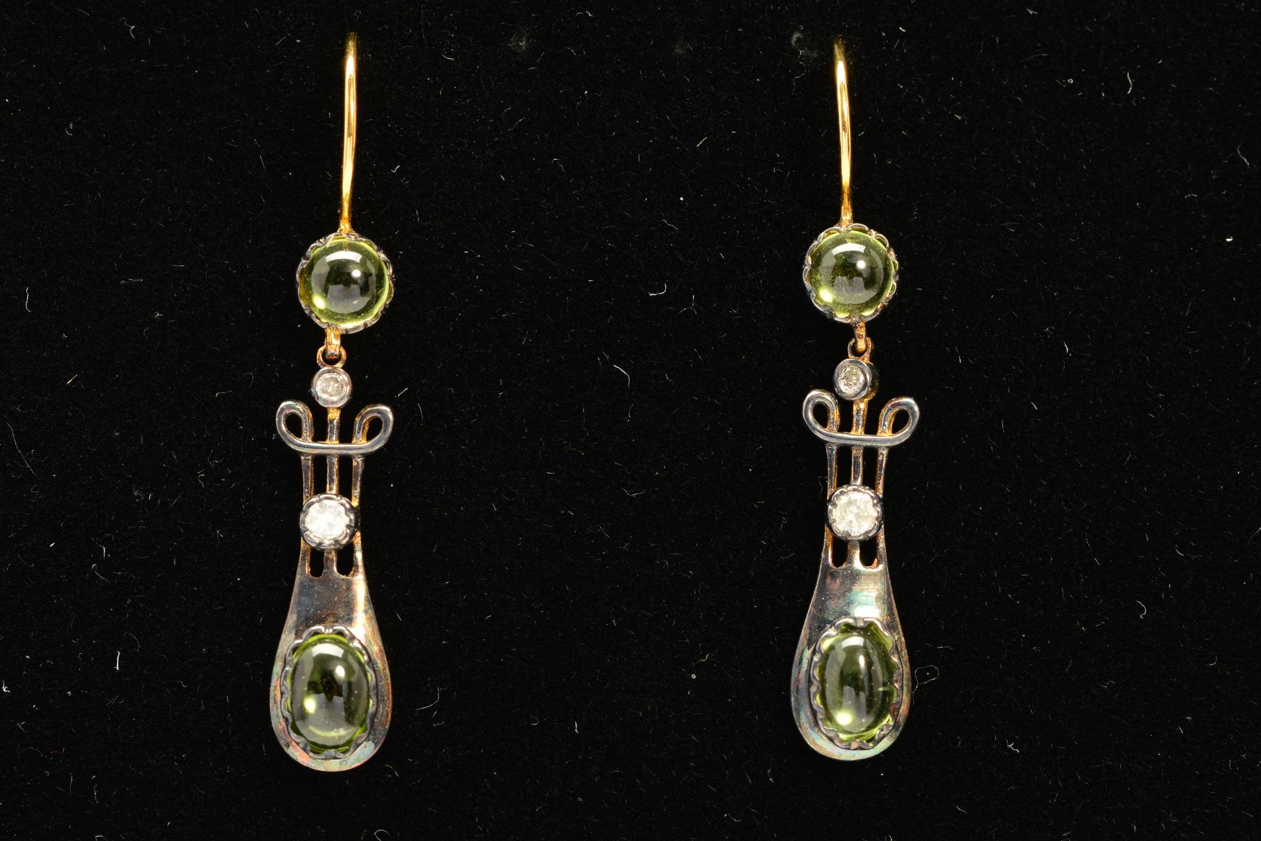 A PAIR OF PERIDOT AND DIAMOND EARRINGS, each designed as an oval peridot cabochon to the tapered,