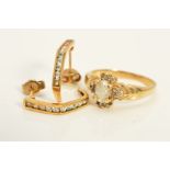 A RING AND A PAIR OF EARRINGS, the ring designed as a central oval cubic zirconia within a