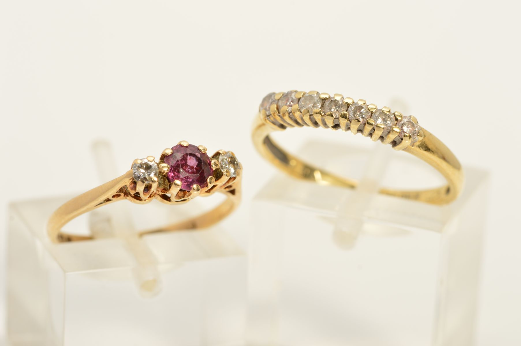 TWO 9CT GOLD GEM SET RINGS, the first a seven stone diamond ring, the line of brilliant cut diamonds