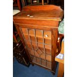 AN OAK LEAD GLAZED SINGLE DOOR BOOKCASE (key)