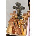 AN EARLY 20TH CENTURY CARVED FREESTANDING WOODEN CRUCIFIX, together with eight wall hanging wooden