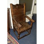 AN 19TH CENTURY AND LATER OAK WAINSCOTE CHAIR, shaped cresting, carved armrest, above block and