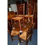 A REPRODUCTION OAK OVAL TOPPED GATE LEG TABLE, together with six oak ladderback rush seated