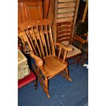 A REPRODUCTION GOLDEN OAK STICK BACK ROCKING CHAIR, together with an oak ladderback chair (2)