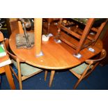 A 1980'S TEAK EXTENDING DINING TABLE and four chairs (5)