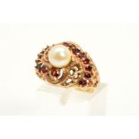 A CULTURED PEARL AND GARNET DRESS RING, designed as central cultured pearl within a textured open