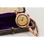 AN EARLY 20TH CENTURY 9CT GOLD WRISTWATCH, the circular face with central engine turned sun ray