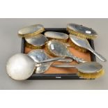 A GEORGE VI FIVE PIECE SILVER BACKED DRESSING TABLE SET, comprising hand mirror and four brushes,