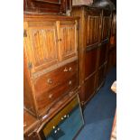 AN OAK LINENFOLD FIVE PIECE BEDROOM SUITE, comprising a two door wardrobe, tallboy, dressing table