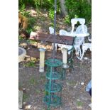 A GREEN PAINTED WROUGHT IRON CIRCULAR GARDEN FOUR TIER STAND together with a pole bird feeder (2)