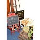 A PAINTED STEEL ARTIST EASEL, together with three various other easels and a painted wall sign (5)