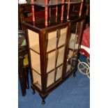 AN EDWARDIAN MAHOGANY TWO DOOR DISPLAY CABINET on ball and claw feet (key)