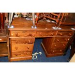A VICTORIAN PITCH PINE KNEE HOLE DESK, with nine various drawers, width 138cm x depth 51cm x