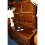 AN OAK LINENFOLD DRESSER with two drawers, width 122cm x depth 49cm x height 182cm