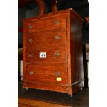 AN OAK MINIATURE CHEST OF FOUR DRAWERS, together with a Bush valve radio and an Edwardian carved oak