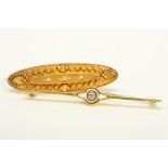 TWO EARLY 20TH CENTURY GOLD DIAMOND BROOCHES, the first of elongated, oval outline, set to the