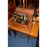 AN OAK SINGER TREADLE SEWING MACHINE and a mahogany cased Singer sewing machine (2)