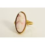 A CAMEO RING, the elongated oval cameo within a collet setting, depicting a lady in profile, stamped