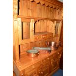 A CARVED PINE KITCHEN DRESSER, double glazed top, above a base section with three short drawers,