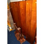 A EDWARDIAN CARVED WALNUT WIND OUT DINING TABLE, with three additional leaves on double legs