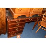 A REPRODUCTION MAHOGANY SINGLE SIDED PEDESTAL DESK, with a brown tooled leather inlay top, one