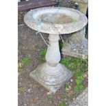 A COMPOSITE CIRCULAR BIRD BATH on a separate base, height 74cm x diameter 52cm