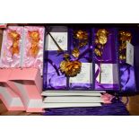 A COLLECTION OF TWELVE BOXED GILT ROSES, with certificates and gift bags