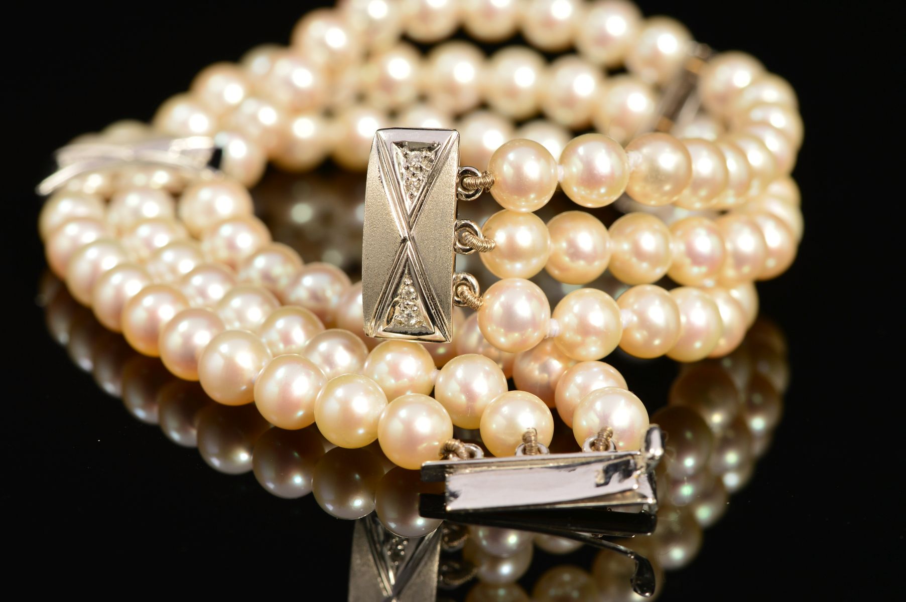 A MODERN 18CT WHITE GOLD, THREE ROW CULTURED PEARL AND DIAMOND BRACELET, each row intersected by a - Image 2 of 3