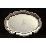 A GEORGE II SILVER MEAT/SERVING PLATTER, of shaped oval form, gadrooned and stepped rim, the