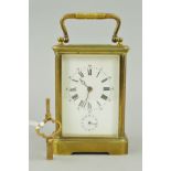 AN EARLY 20TH CENTURY FRENCH BRASS CASED ALARM CARRIAGE CLOCK, with carrying handle above oval