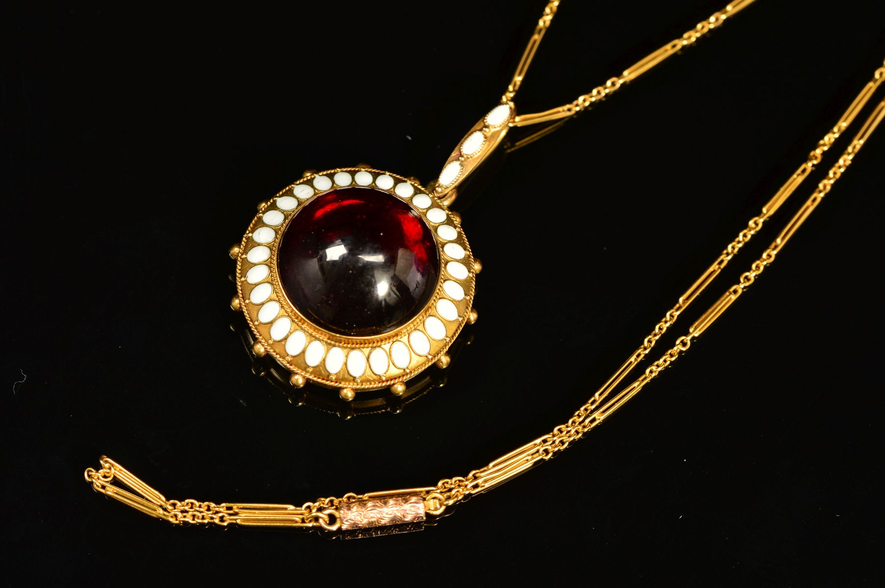 A MID VICTORIAN GOLD GARNET AND WHITE ENAMEL PENDANT, centring on a large cabochon circular garnet - Image 2 of 5