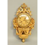 A 20TH CENTURY ROCOCO STYLE GILTWOOD CARTEL CLOCK, ribbon surmount, circular gilt metal dial with