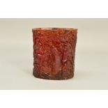 A CARVED AMBER STYLE BRUSH POT, decorated throughout with oriental decoration of monkeys in trees,