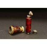 A LATE VICTORIAN RUBY GLASS DOUBLE ENDED SCENT BOTTLE, of decagonal form, one end with hinged