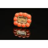 AN EARLY 19TH CENTURY CORAL MOURNING BROOCH, rectangular form with