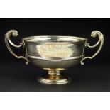 A LATE VICTORIAN SILVER TWIN HANDLED TROPHY CUP, of circular form, cast scrolling handles, the cup
