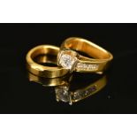 TWO RINGS, the first an abstract design diamond ring, centring on a principle modern round brilliant