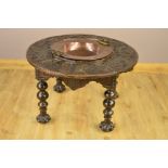 A 17TH CENTURY STYLE CIRCULAR OAK BRAZIER TABLE, circa 1900 and later, fitted with a twin handled