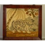 AN EARLY 19TH CENTURY NEEDLEWORK PICTURE OF A TIGER PROWLING IN A LANDSCAPE WITH PALM TREE,