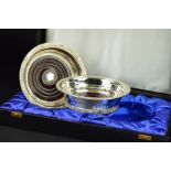 A CASED PAIR OF LATE 20TH CENTURY IRISH SILVER BOTTLE COASTERS, Celtic design borders of scrolls and
