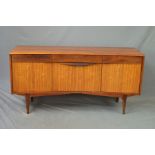 AN ELLIOTS OF NEWBURY TEAK AND ZERBAWOOD FRONTED CONCAVE SIDEBOARD, reed fronted, central fall front