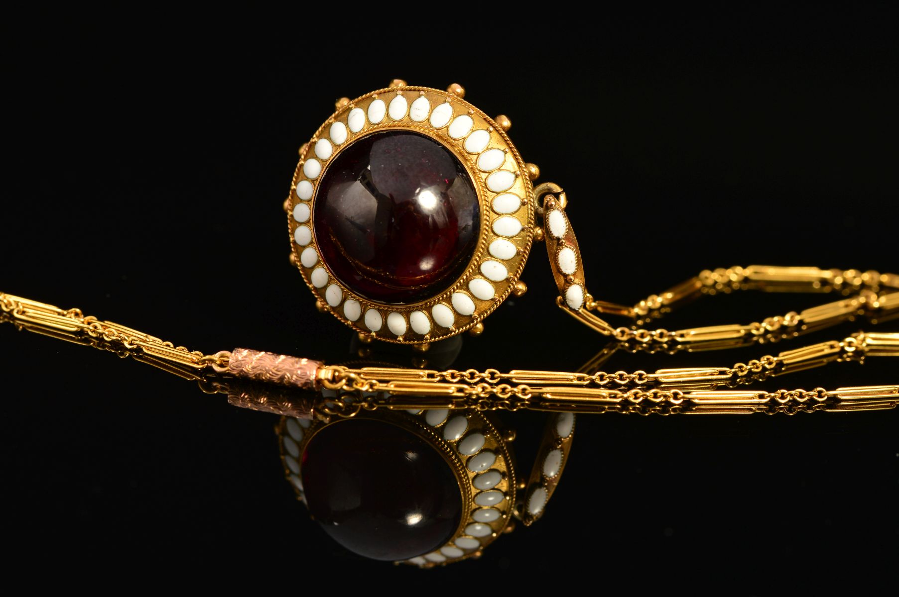 A MID VICTORIAN GOLD GARNET AND WHITE ENAMEL PENDANT, centring on a large cabochon circular garnet - Image 3 of 5