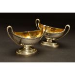 A PAIR OF GEORGE III SILVER DIVIDED TWIN HANDLED SALTS, of oval form, beaded rims, gilt interiors,