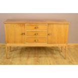 A GORDON RUSSELL OF BROADWAY WALNUT SIDEBOARD, flanked by cupboard doors and the three central