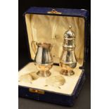 A GEORGE V CASED SILVER MAPPIN & WEBB SILVER CREAM JUG AND SUGAR CASTER, both of girdled baluster