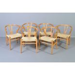 IN THE MANNER OF HANS WEGNER, a set of six light ash wishbone chairs with a rush seat (condition: