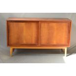 IN THE MANNER OF POUL HUNDEVAD, a 1960’s Danish style teak panelled double sliding door sideboard,