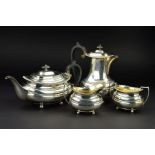 A GEORGE V SILVER FOUR PIECE TEA SERVICE, of oval form, gadrooned rims, over a lobed girdle, on four