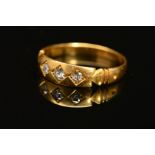 A LATE VICTORIAN 18CT GOLD THREE STONE DIAMOND RING, designed as three old cut diamonds claw set