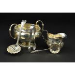 A GEORGE V SILVER TWIN HANDLED SUGAR BOWL, of circular form, cast bobbin rims, 'C' scroll handles,